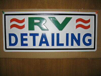 The framed logo of RV DETAILING on a wall