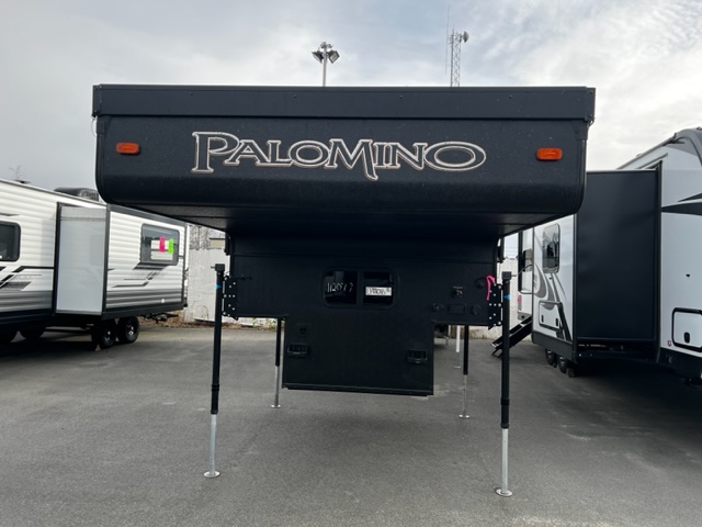 Black colored Palomino truck camper