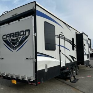 A white colored Carbon 377 Toy Hauler 5th wheel