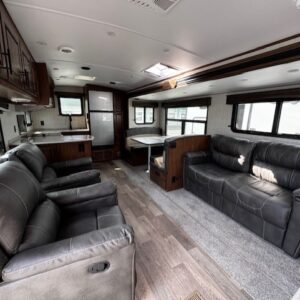 Spacious RV interior with leather seating.