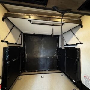 Camper interior with foldable bed mechanism.