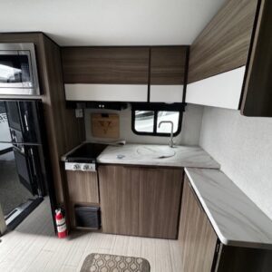 RV kitchen interior with modern cabinetry.