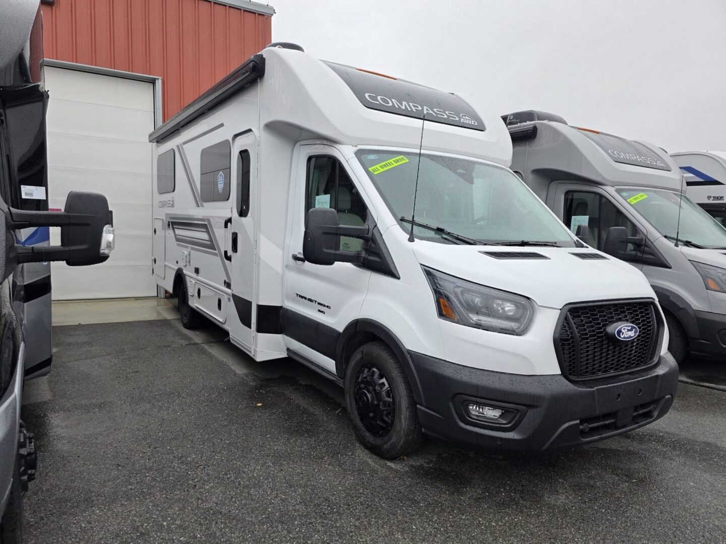 White Ford Compass RV parked at dealership lot.