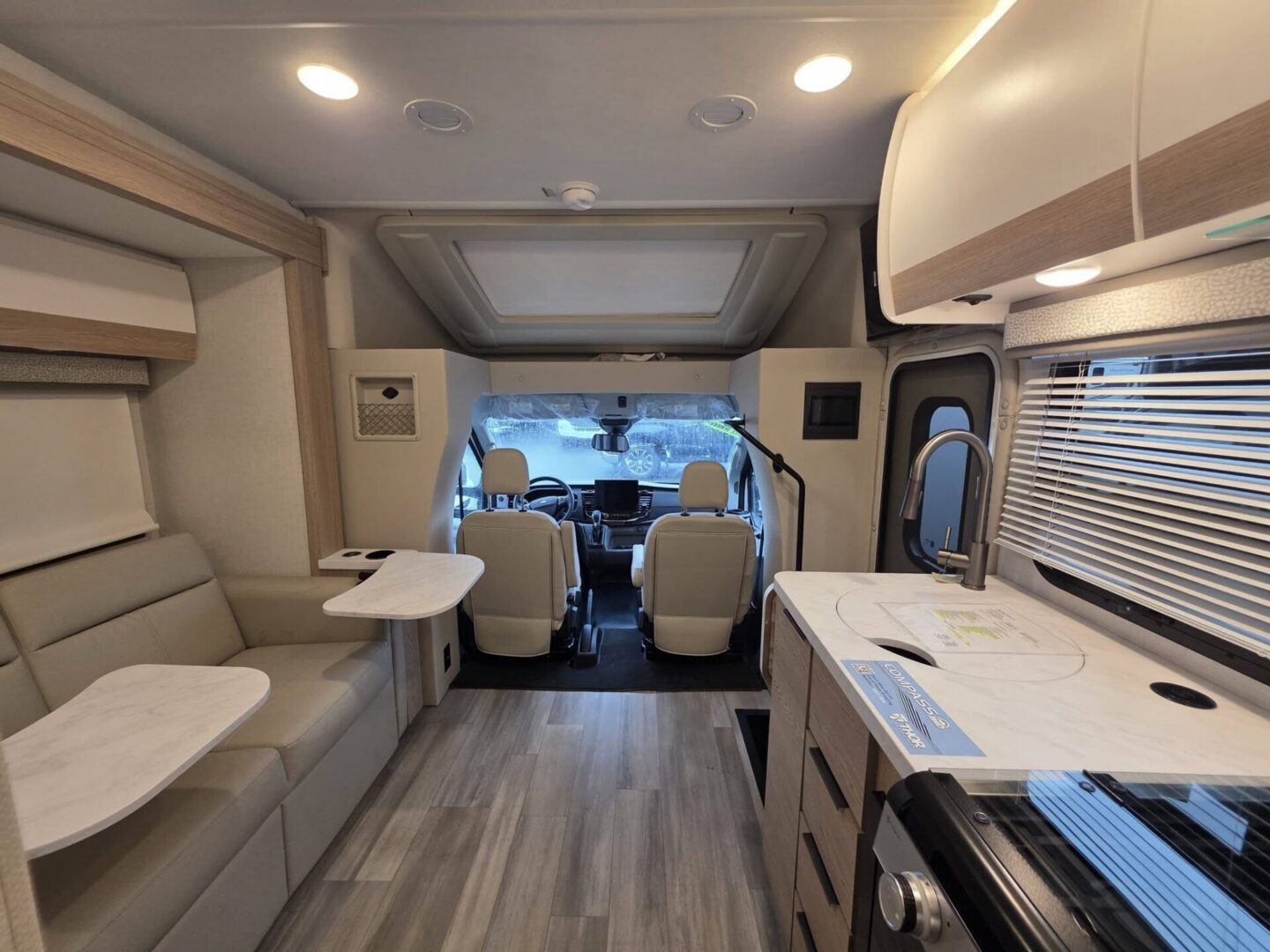 "Stylish RV interior with seating and kitchen."