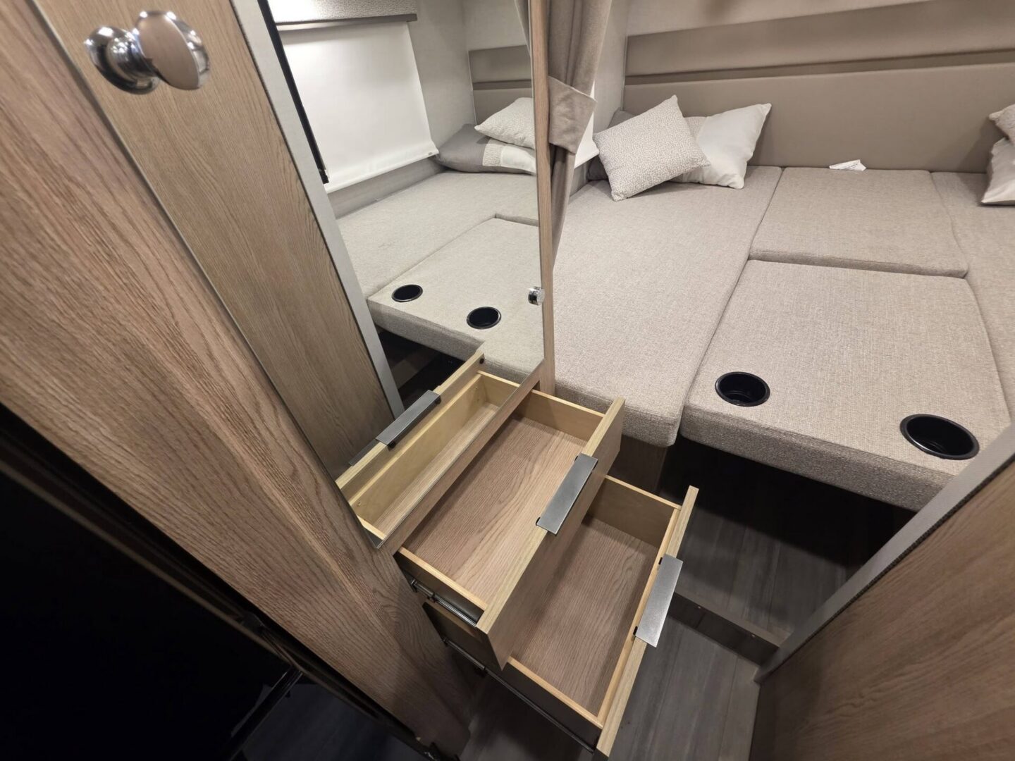 Cozy camper seating area with storage drawers.