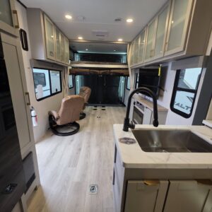Spacious RV interior with modern kitchen design.