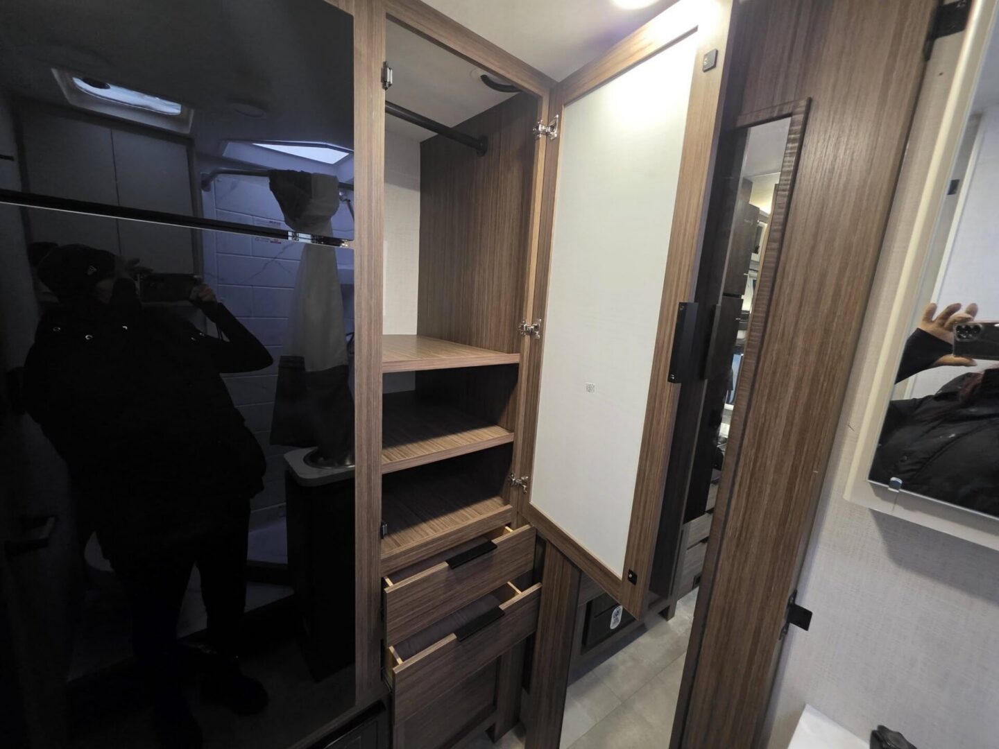 "Interior storage cabinet with shelves and mirror."