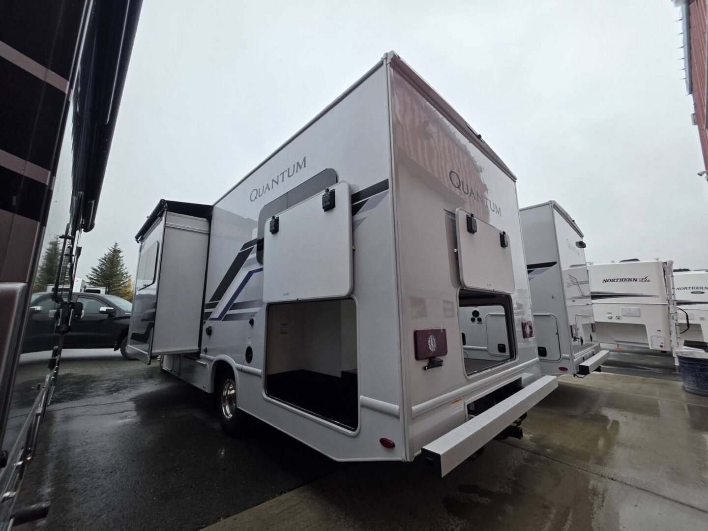 "Side view of Quantum travel trailer parked."