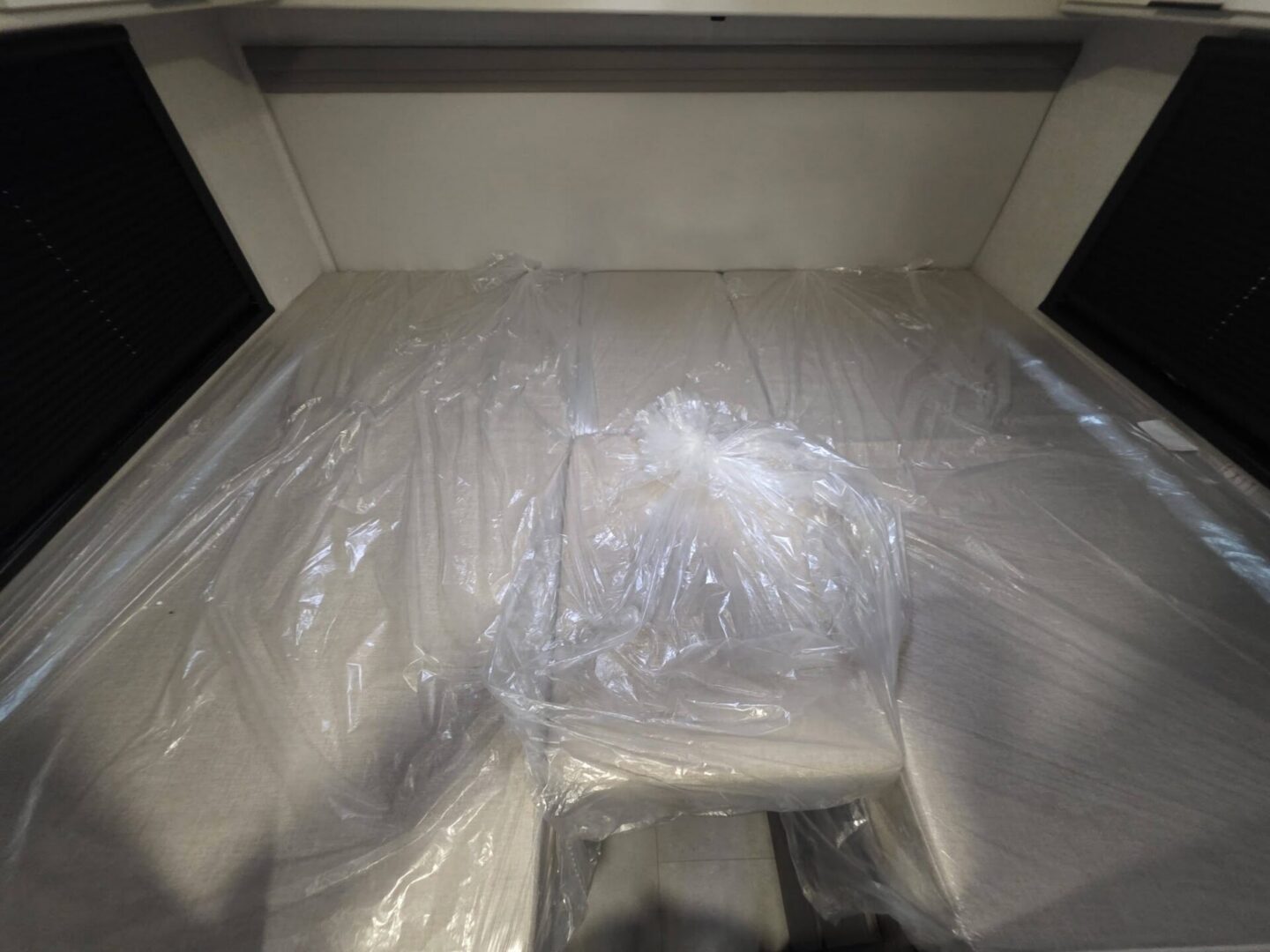 "Interior view of camper with protective plastic covering."