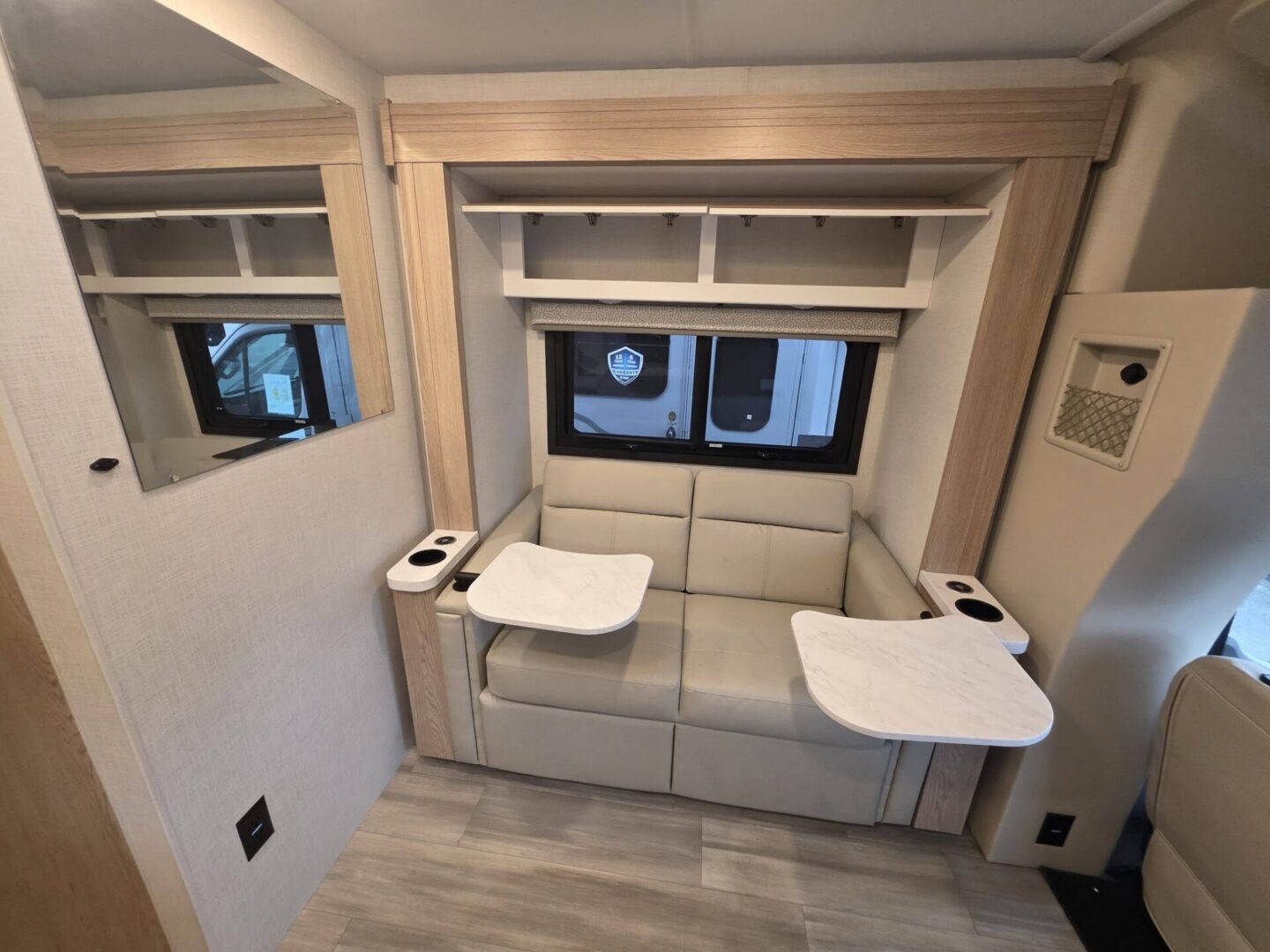 Modern camper seating area with foldable tables.