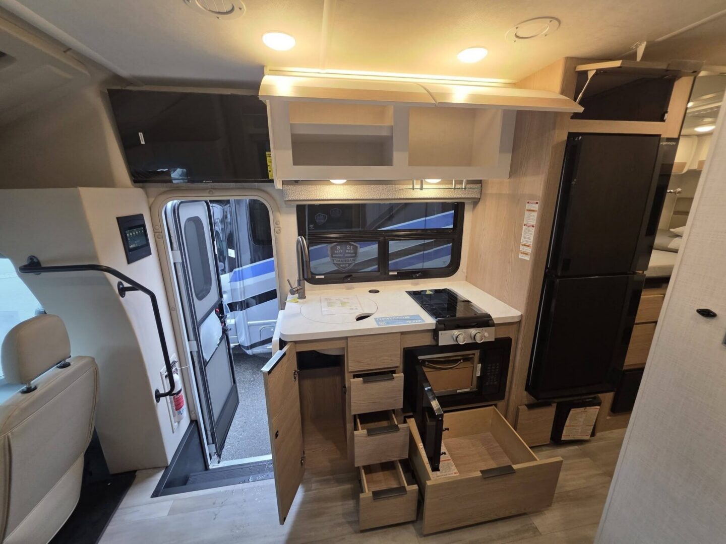 "Modern camper kitchen with ample storage space."