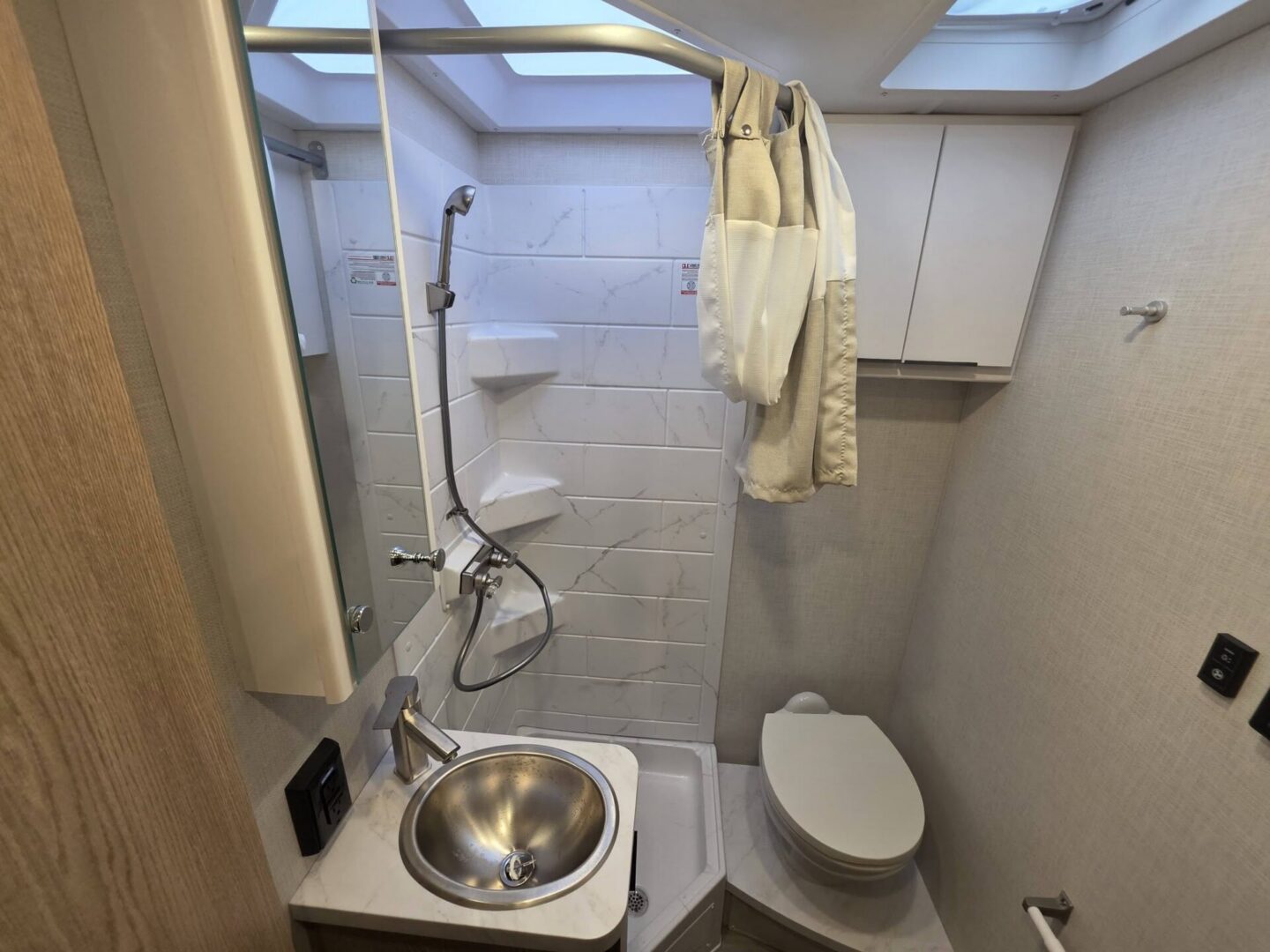 Compact bathroom with shower and sink features.