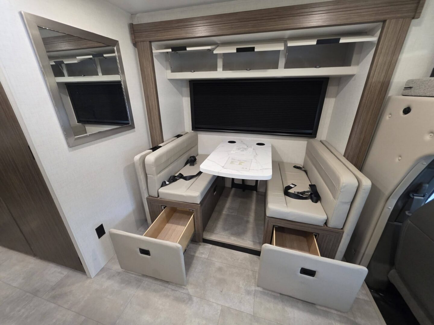 Modern camper dining area with storage drawers.